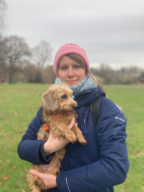 Frieda the dachshund puppy in the arms of her owner